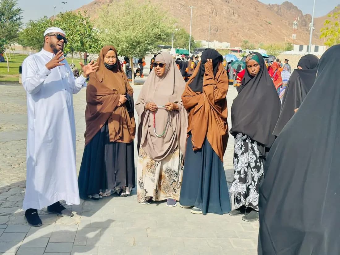 An STS guide briefing a group of women pilgrims at a ziyarah site