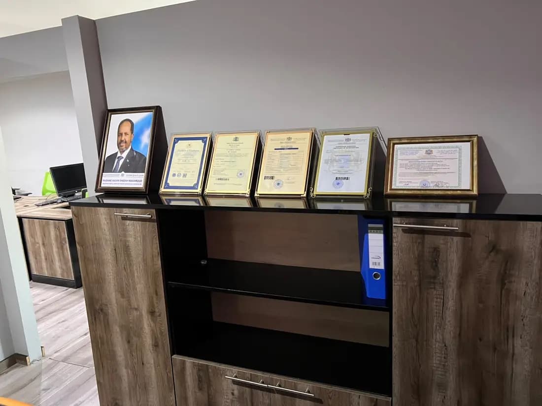 Framed STS certificates on a shelf in the Mogadishu office